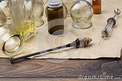 Retro medical jars for vacuum therapy and vintage reusable syringe Stock Photo