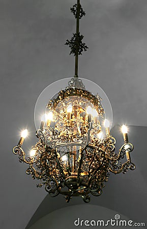 Old medieval chandelier with modern light bulbs Stock Photo