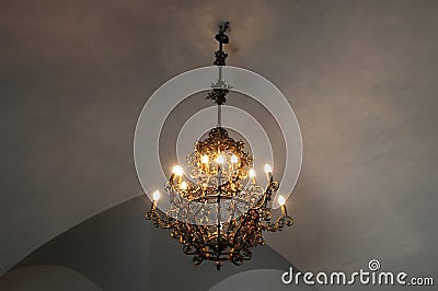 Old medieval chandelier with modern light bulbs Stock Photo