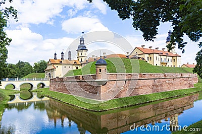 An old medieval fortified castle surrounded by moats filled with water. Residential castle of the Radziwil family in Niasvizh, Stock Photo