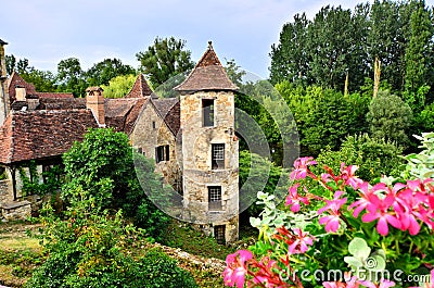 Medieval house and tower with flowers in Carennac, France Stock Photo