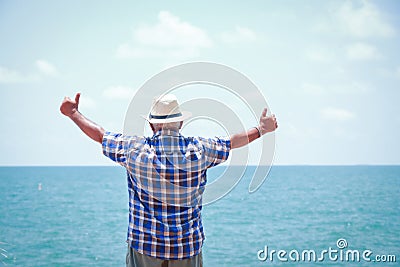 Old men go to the beach to relax Stock Photo