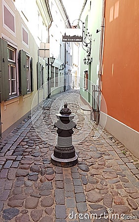 Old metal decorative stand on a narrow pedestrian street in the Latvian capital Riga at the end of April 2020 Editorial Stock Photo