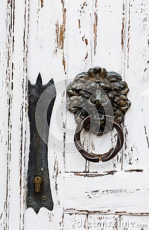 antique door handle in the form of a lion on a white wooden door, close-up Stock Photo