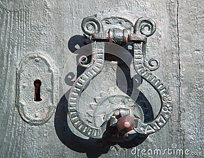 Old metal door handle mediterranean style Stock Photo