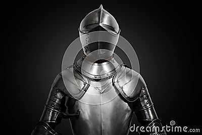 Old metal knight armour on black background Stock Photo