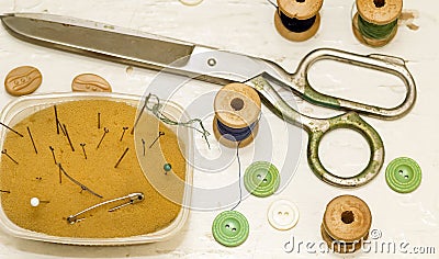 Old metal scissors, needles and wooden coils top view Stock Photo