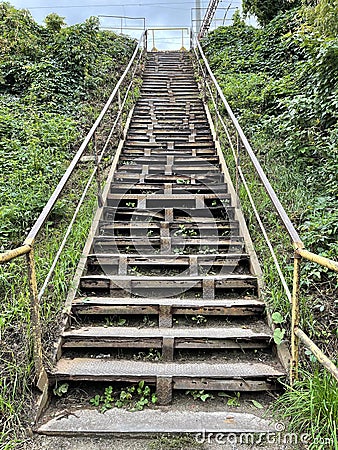 Old metal stairway outdoors in grass Stock Photo