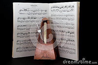 Old metronome with sheet music Stock Photo