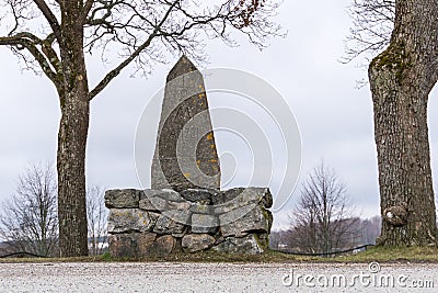 An old milestone in granit stone with text 1781 Stock Photo