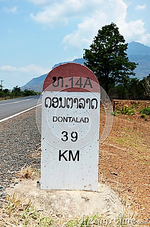 Old Milestone on the road information distance Dontalad with Pakse Editorial Stock Photo