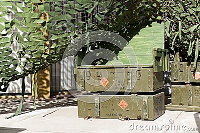 Old military green wooden boxes under a grid Editorial Stock Photo