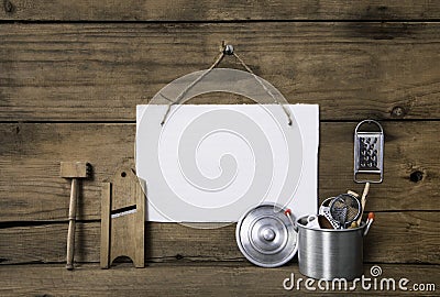 Old miniatures of kitchenware with a white placard on an old woo Stock Photo