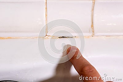 old mold destroy join lines in bathroom. old silicone sealant Stock Photo