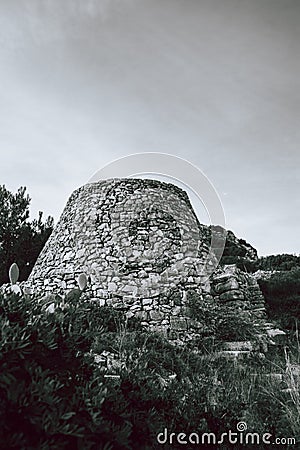 Old monumental castle ruin black and white-shot with beautiful orange sky in Puglia, Italy Stock Photo