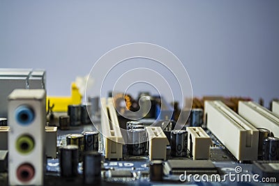 The old motherboard from the computer of blue color. Texture. Spare parts. Repair. Personal computer details. Equipment. Stock Photo