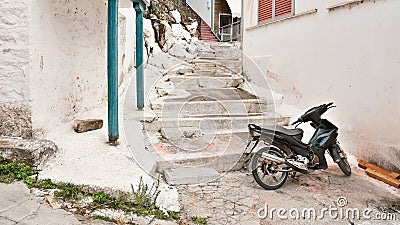 Old motorcycle on narrow white stone streets Stock Photo
