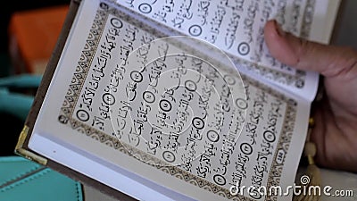 Muslim Hands Holding Quran. Stock Photo