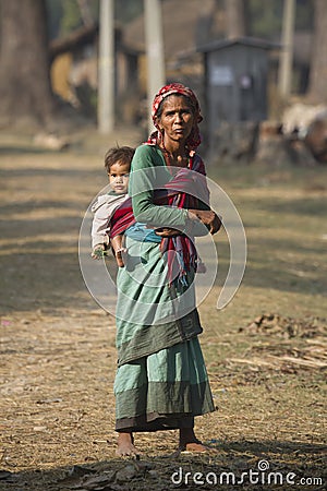 Old nepali woman carrying a young boy Editorial Stock Photo