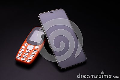 Old and new telephone on blackbackground. Stock Photo