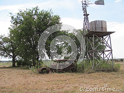 An old north Texas farm complete with windmill and old 1930`s car. Stock Photo