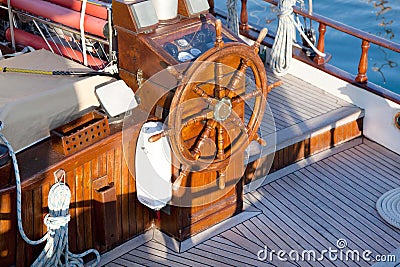 Old nostalgic sail boat - cockpit and rudder of teak wood. Stock Photo