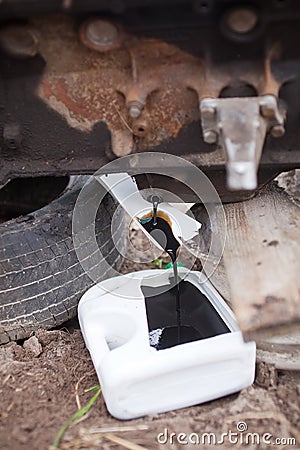 Old oil from the engine merges into field conditions Stock Photo