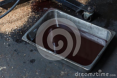 Old oil tray that was removed from the automobile. Old black oil lubrication engine vehicle motor car used leak or drip spill from Stock Photo