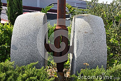 Old olive oil mill and olive crushing stone Stock Photo