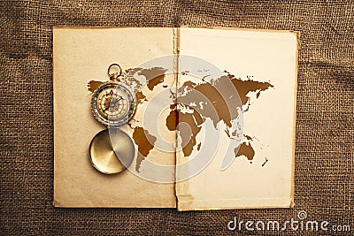 Old open book with compass and world map Stock Photo