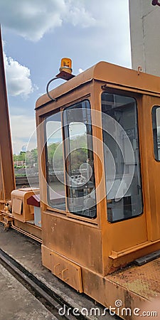 Old, Orange crane control cabin Stock Photo