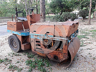 Old orange road roller is dirty. Can not drive Stock Photo