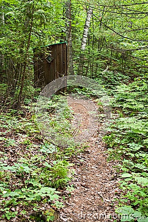 Old Outhouse in the Woods Stock Photo