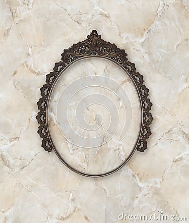 Old oval picture frame metal worked on marble background Stock Photo