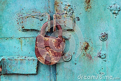 Old padlock on a blue door Stock Photo