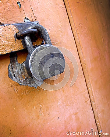 Old padlock on old brown painted door Stock Photo