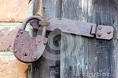An old rusty padlock for closing ranch doors. Stock Photo