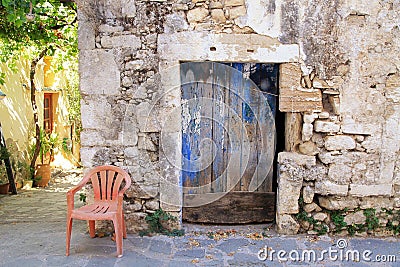 Old painted blue door on the ancient stone wall, Greece Stock Photo