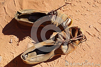 Old pair of shoes on sand Stock Photo