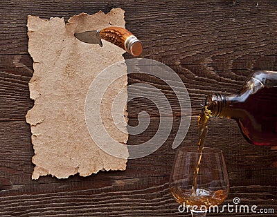 Old paper pinned to a wooden wall with a knife Stock Photo