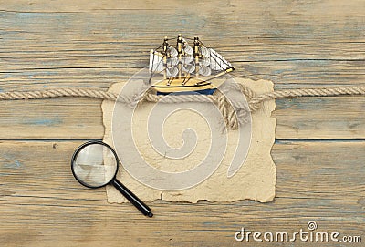 Old paper and model classic boat on wood background Stock Photo