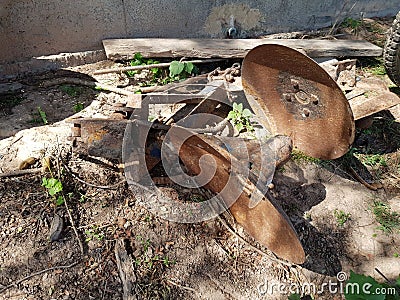 Old parts from the tractor Put it under the shade of trees Stock Photo