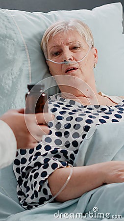 Old patient receiving bottle of pills for recovery from medic Stock Photo