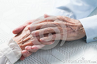 Old people holding hands Stock Photo