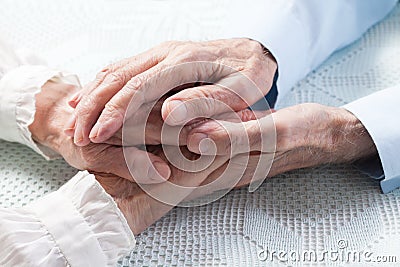 Old people holding hands Stock Photo