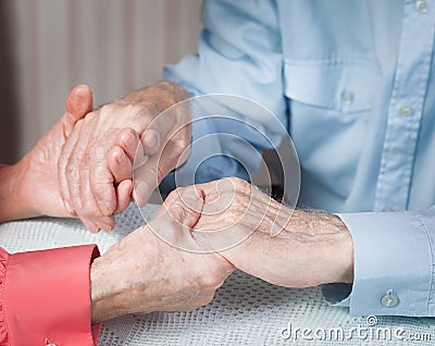 Old people holding hands closeup. Elderly couple. Stock Photo