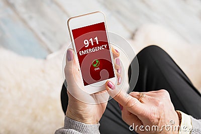 Old person dialing emergency number 911 on phone Stock Photo