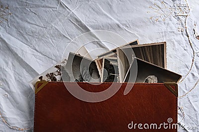 Old photo albums lie on white mint tablecloth, vintage photographs, concept of family tree, genealogy, childhood memories, Stock Photo