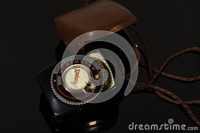 Old photo light meter in a case on a mirror table Editorial Stock Photo