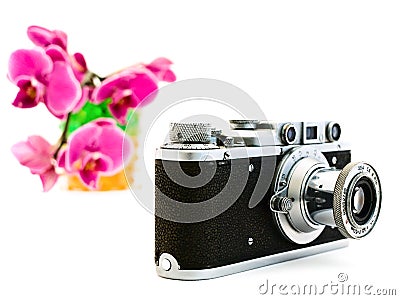 Old photocamera and pink orchid Stock Photo